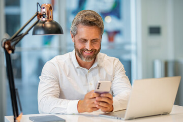 Office manager man use laptop and phone. Agile business. Professional businessman has communication online. Business chat. Hispanic businessman working online. Business success