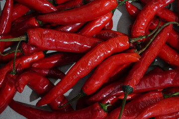 a pile of red chili in the basket