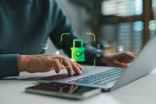 Hands typing on laptop keyboard with cybersecurity interface icon, green lock and checkmark symbolizing data privacy, secure connection, online protection for digital online safety.