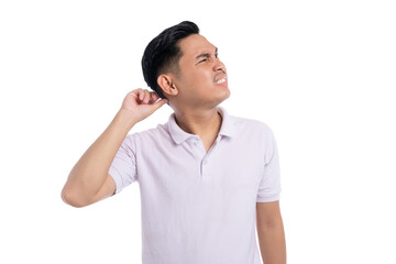 Young man scratching head and looking confused with uncertain facial expression isolated on...