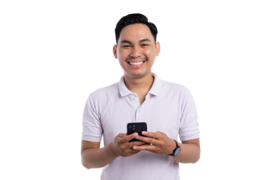Smiling young man using smartphone while standing and looking at camera isolated on transparent background