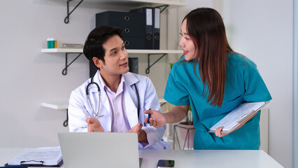 Doctor and Nurse Collaborate on Patient Care: A doctor and nurse discuss a patient case while...