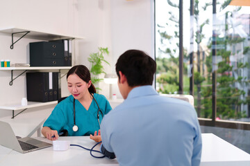 Asian Doctor Woman Checking Patient Blood Pressure in Clinic Medical Healthcare Professional...