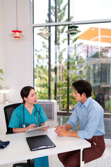 Healthcare Consultation: A dedicated female medical professional discusses health concerns with a patient in a modern clinic setting, fostering trust and open communication.