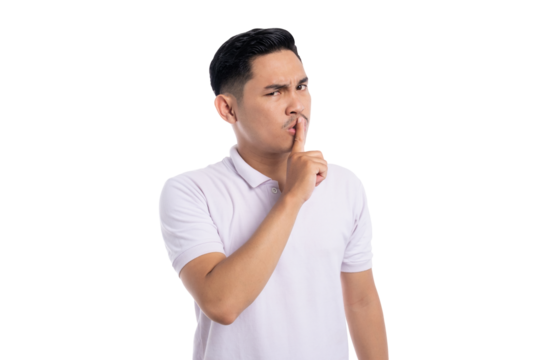 Serious young man making silence gesture with index finger on lips asking to be quiet isolated on transparent background