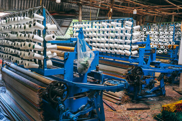 workshop with weaving machines for production of woven reed mats in Vietnam in Asia
