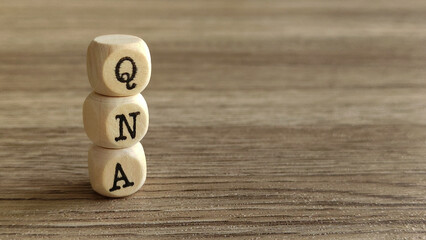 QNA Blocks on a Wooden Surface