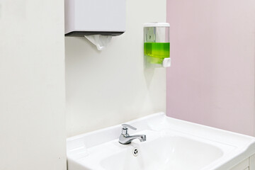 Stylish white sink and toilet paper in a modern bathroom interior