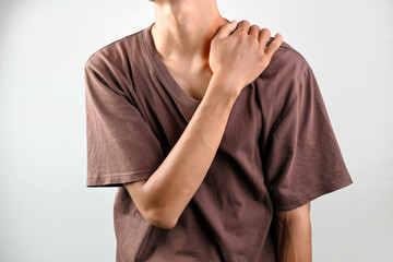 Portrait of a man suffering shoulder pain isolated over a white background. Concept of healthcare