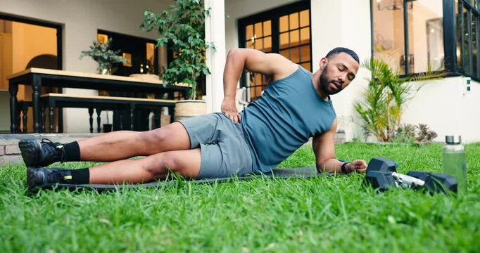 Fitness, side plank and man outdoor for workout, training or stretching for core strength. Health, wellness and male person with smart watch and weights for exercise for ab muscles in backyard.