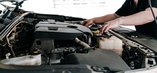 A skilled mechanic meticulously working on a car engine, showcasing precision and expertise in vehicle maintenance. Ideal for automotive repair.