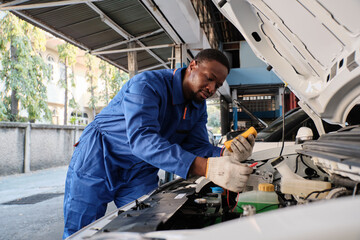 EV car check, Black male mechanic worker inspects and maintains service of electric engine and...