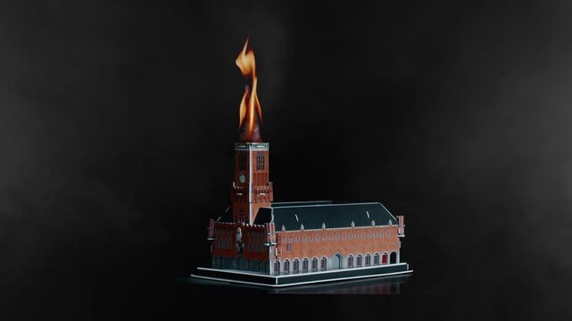 Belfry of Bruges bell tower 13th century Gothic building struck by fire, miniature act against black background, Studio shot, Bruges
