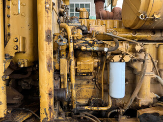 Heavy Equipment Engine A close-up shot highlighting the robust machinery of a bulldozer engine, with intricate details of its mechanical components, exuding power and durability.