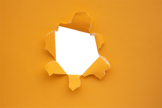 Torn ripped orange paper hole isolated on white background