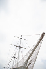 Obraz premium masts of a wooden sailing ship in the roadstead