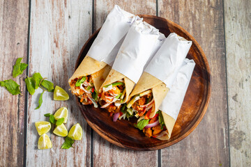 Chicken shawarma roll is a Middle Eastern wrap made with spiced grilled chicken, garlic sauce,...