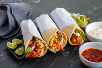 Chicken shawarma roll is a Middle Eastern wrap made with spiced grilled chicken, garlic sauce, pickled veggies, and flatbread, served warm and flavorful.
