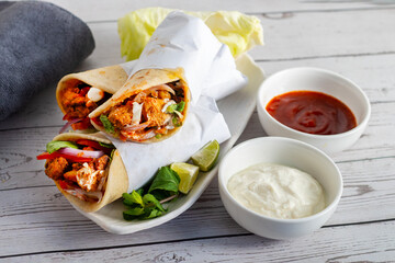 Chicken shawarma roll is a Middle Eastern wrap made with spiced grilled chicken, garlic sauce,...
