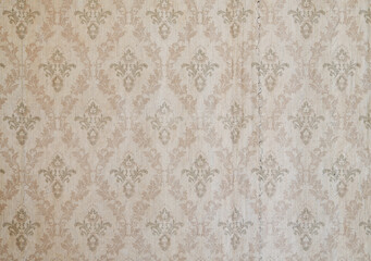 Old wallpaper on the wall. Old wallpaper for texture or background.