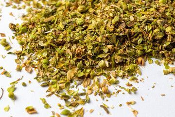 Dried crushed oregano - white background