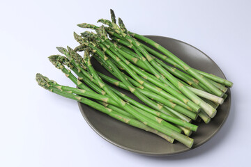Fresh green asparagus on white