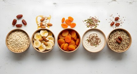 Top View of Healthy Breakfast Ingredients with Oats, Banana, Apricots, Yogurt, and Quinoa Bowls