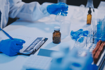 Research, experiment and medical trial being done by a scientist in a lab, science facility or hospital. One young, serious and professional researcher organizing, sorting or making a discovery