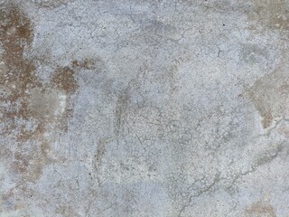 Weathered Concrete Surface with Cracks and Stains. Close-up of an old concrete wall showing cracks...