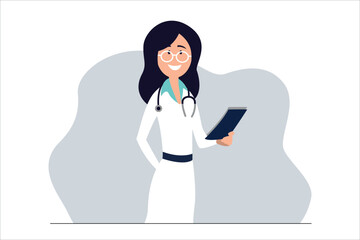 A happy female doctor or nurse in a white coat with a stethoscope and a notebook stands and smiles.

