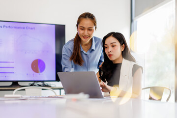  Two business woman lawyer or company employee holding accounting bookkeeping documents checking financial data or marketing report working in office with laptop. Paperwork management
