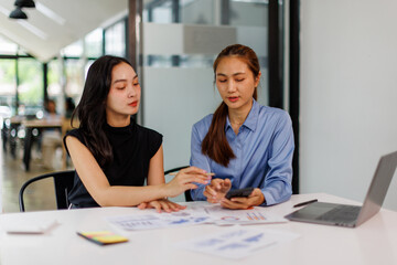 Two asian business woman Accounting using calculating income-expenditure and analyzing real estate investment data report Financial and tax systems concept.	