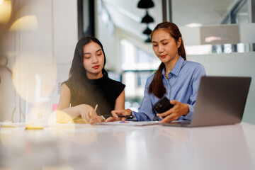 Two asian business woman Accounting using calculating income-expenditure and analyzing real estate investment data report Financial and tax systems concept.	