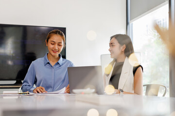 Business asian woman Reviewing Documents, business woman's hands meticulously reviewing a stack of...