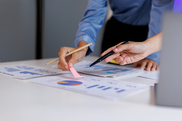 Financial analysts analyze business financial reports on a digital tablet planning investment...