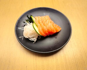 sushi on a plate,Balikpapan Indonesia 31 May 2025,Salmon sashimi,Raw salmon steak ,Salmon fillet is authentic japanese food,traditional japanese cuisine.Decorated with vegetables and noodles