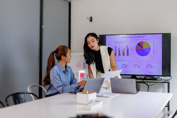 Team of Business asian woman Reviewing Documents, business woman's hands meticulously reviewing a...