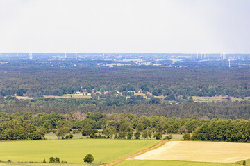 Landscape view to the horizon with fields and wind turbines