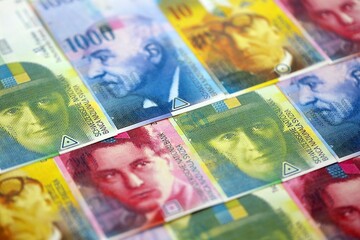 Swiss franc banknotes. The current francs money bills lies on table in big amount close up