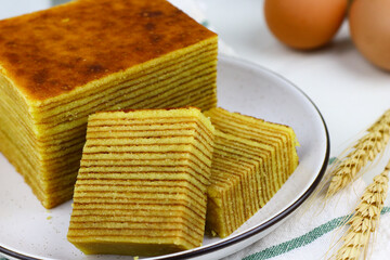 Lapis Legit or Spekkoek, One of Indonesian traditional layered cake. Lapis legit especially served during celebration or special day. White marble background.
