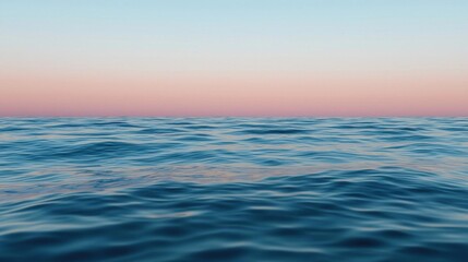 Photograph of the ocean at sunset. the sky is a beautiful shade of pink and blue, with the horizon line visible in the distance.