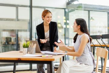 Two professional caucasian asian business women friends collaboration, working together at office, using laptop, Generally accepted audit standards, Earnings before interest and taxes
