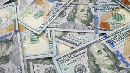 Detailed closeup shot of United States Currency Concentration on Hundred Dollar Bills