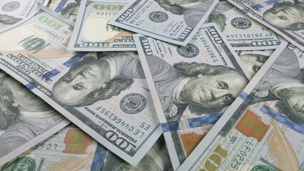 A collection of scattered U.S. Dollar Bills arranged across a flat surface area