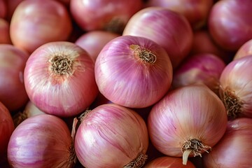 Fresh pink onions arranged closely, showcasing their smooth skin and vibrant colors.