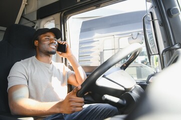 Young handsome African American man working in towing service and driving his truck