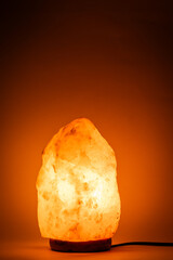 Salt lamp with warm orange light.