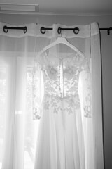 wedding dress white gown in home for a bride hanging in bedroom room for marriage day