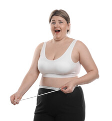 Weight loss. Emotional plus size woman measuring waist with tape on white background