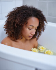 Relaxing bath experience with flowers in a calm home setting during the evening